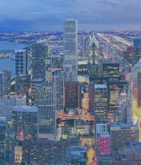 a cityscape with many tall buildings and a body of water