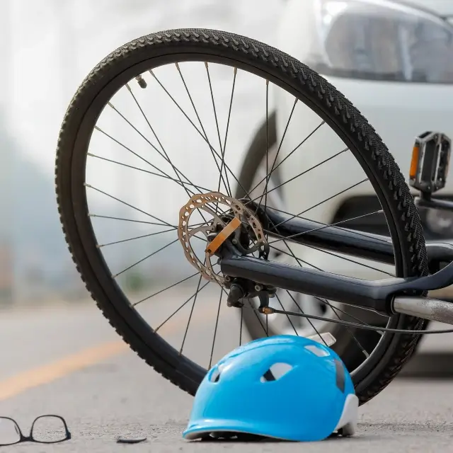 a bicycle wheel and helmet on the ground
