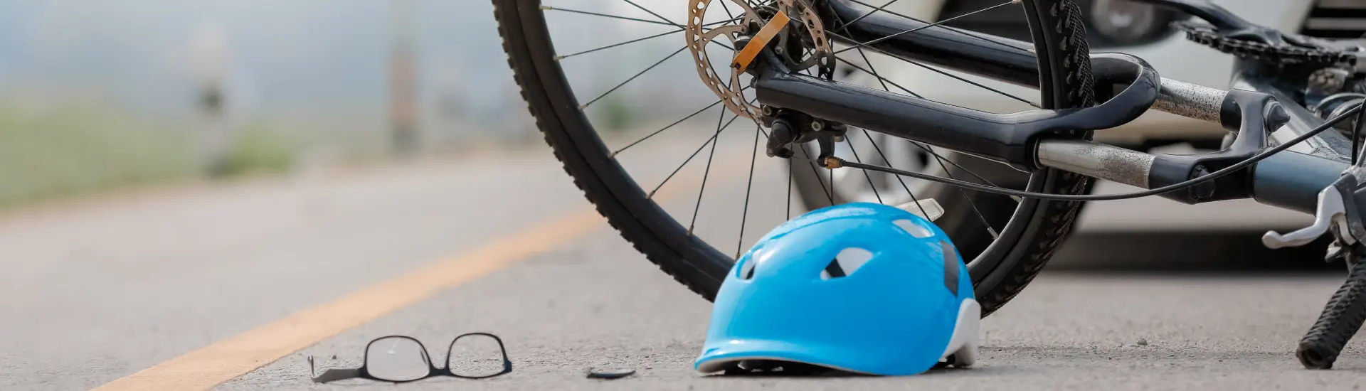 a bicycle wheel and helmet on the ground