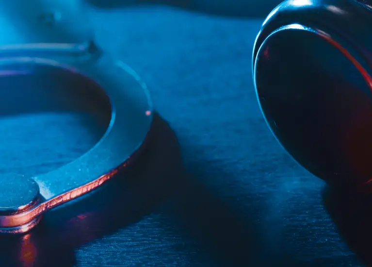A close up of a gavel and a handcuff