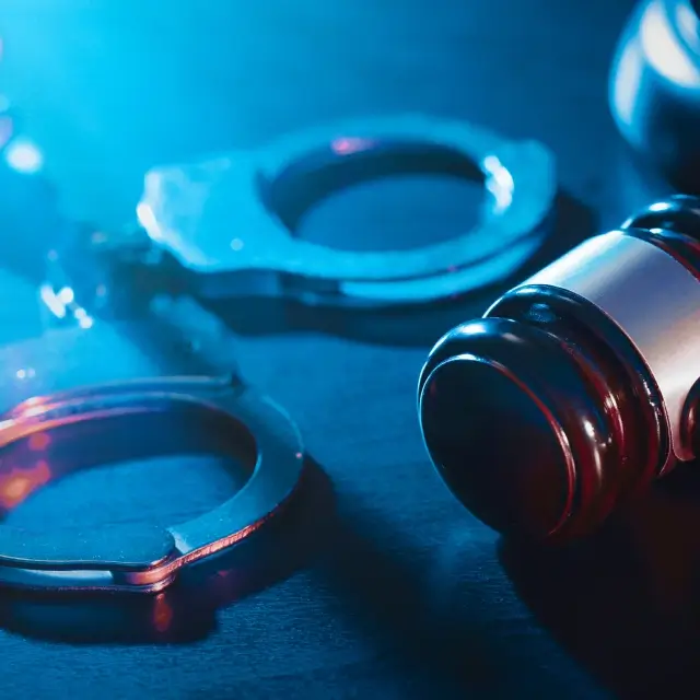 A close up of a gavel and a handcuff