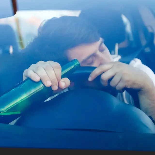 a person holding a green bottle