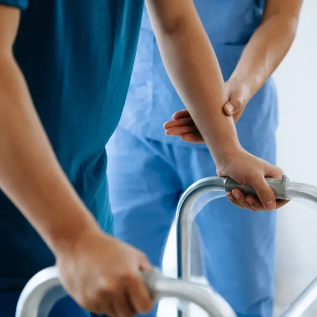 a close-up of a patient holding a walker