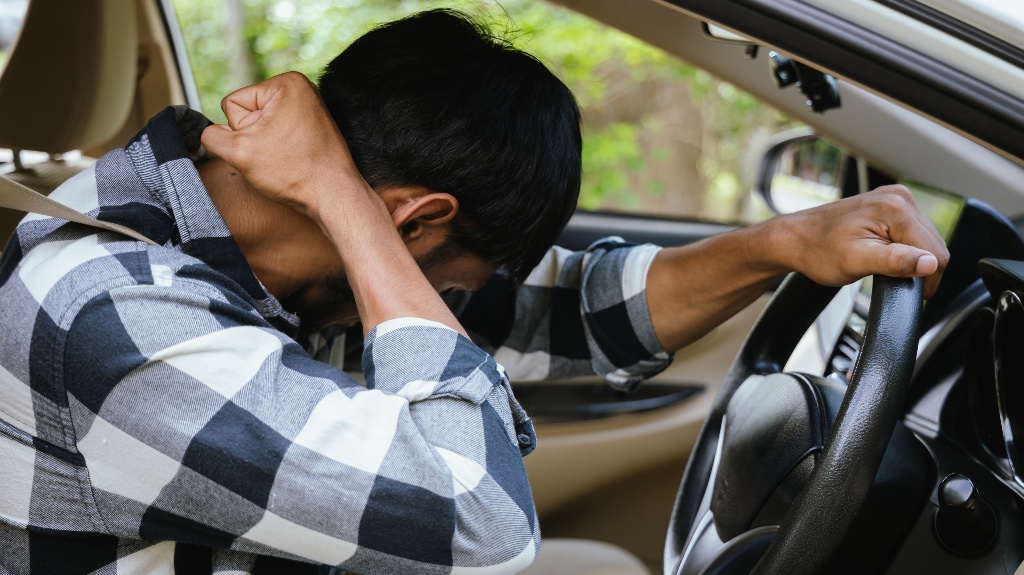 Man holding his neck in car accident