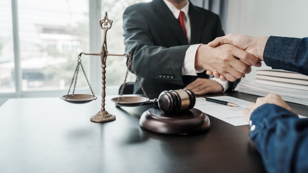 Lawyers and client shaking hands