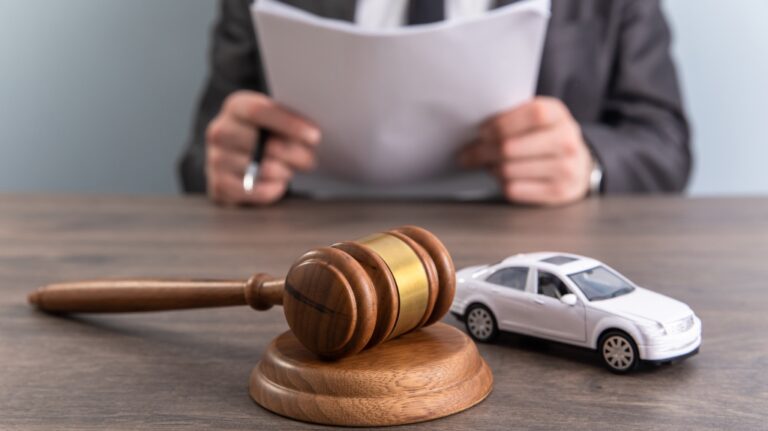 Model of car and gavel