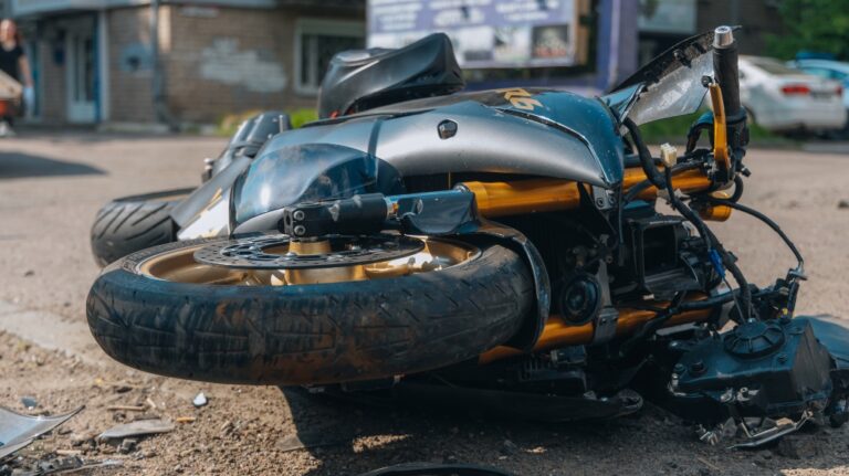 The motorcycle lies on the road after the collision