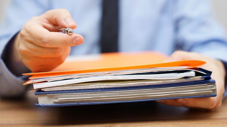 lawyer hands over folders with documents