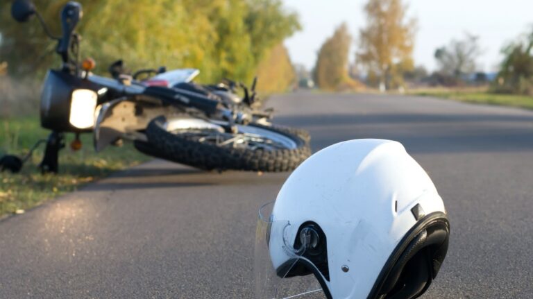 motorcycle and helmet lying on the road