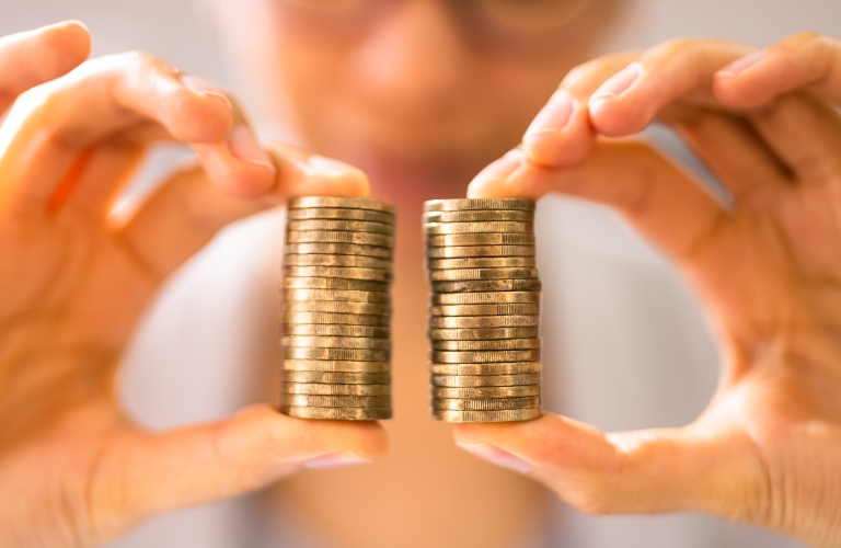 woman holding towers of coins in her hands