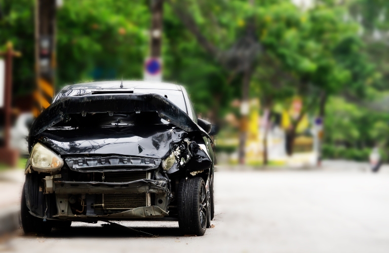 A black car with a smashed front end