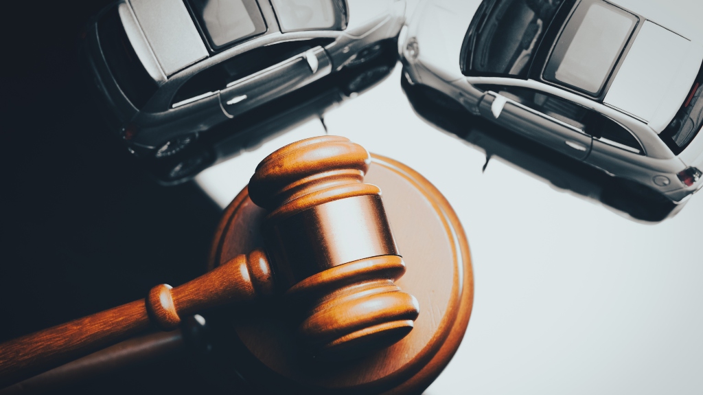 judge's gavel and two cars after the accident