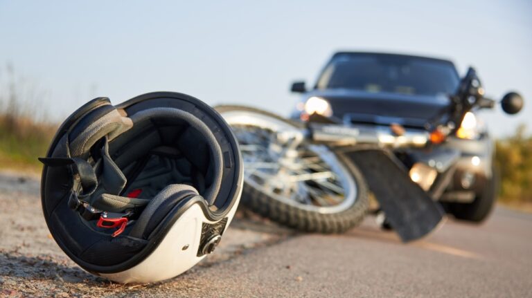 car, helmet and motorcycle on road