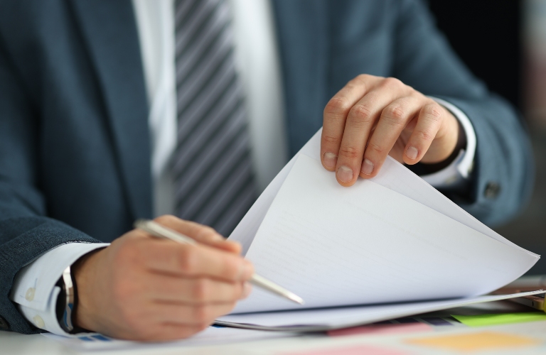 lawyer in suit holding documents