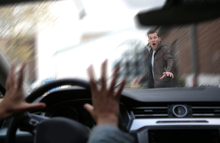 young male pedestrian has an accident with a car