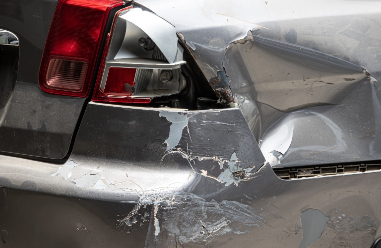 A car with a smashed rear end
