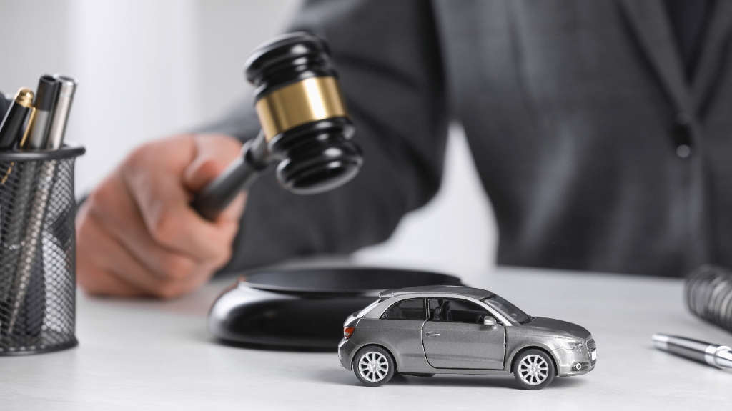 lawyer with judge's gavel and toy car