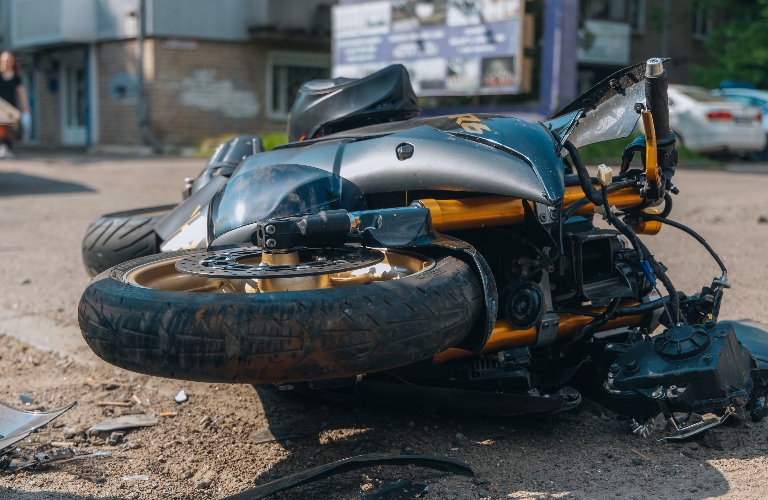 motorcycle lies on the road after the collision