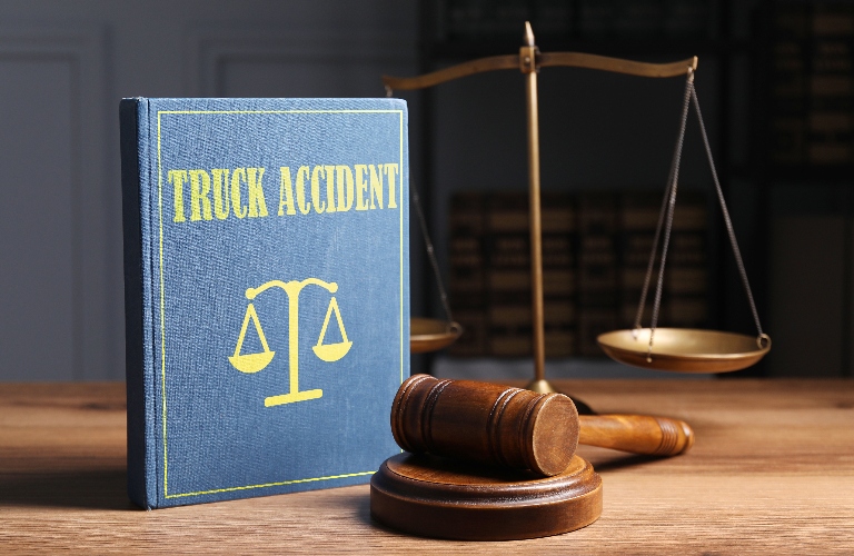 truck accident law book with judge gavel