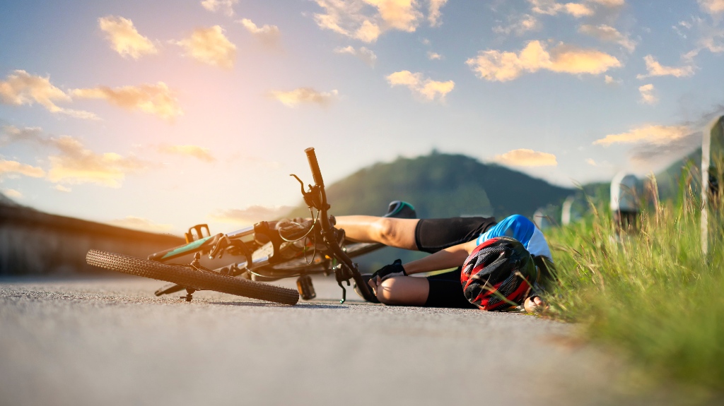 young woman on the ground after bicycle accident