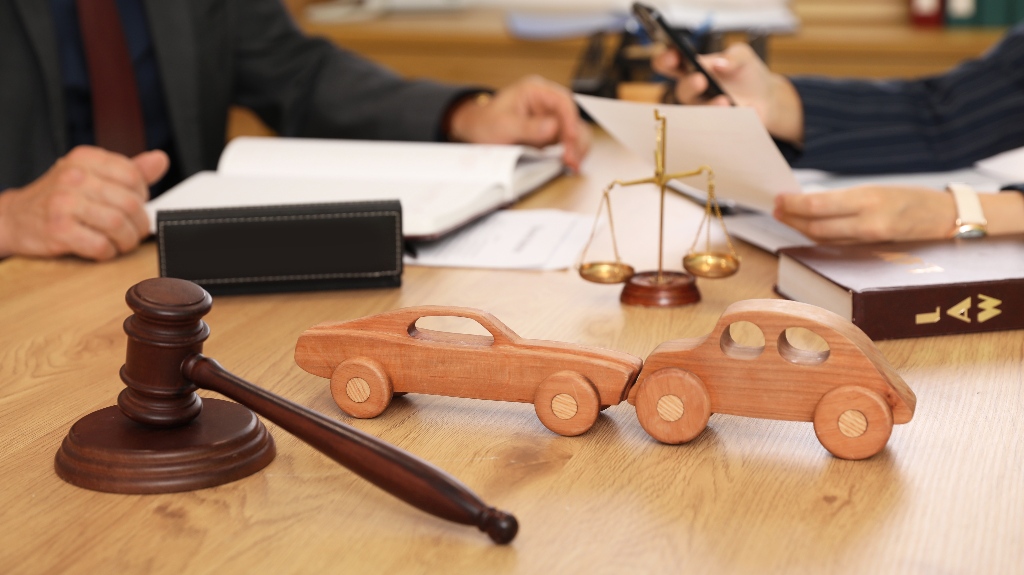 Wooden cars with judge's gavel on lawyer's table