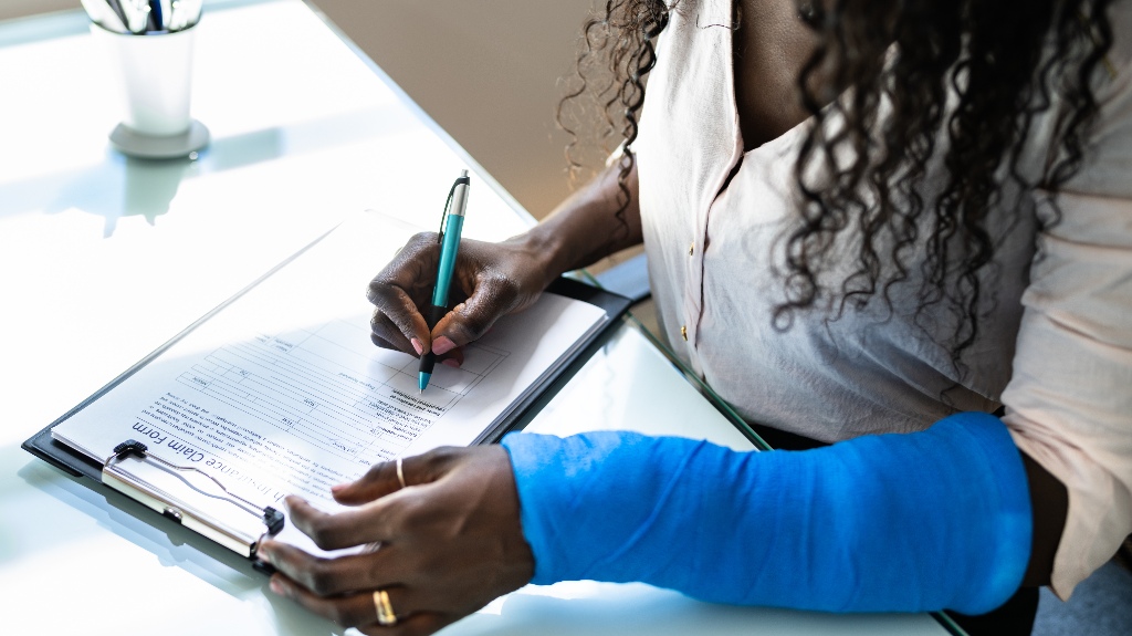 injured woman is filling out documents after rideshare accident