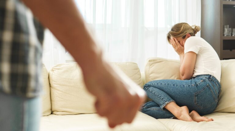 Man is threatening wife with his fist