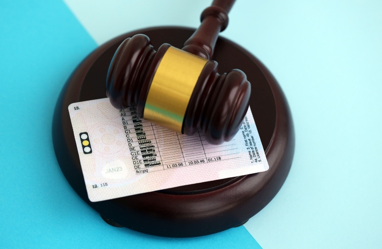 Generic driving license and judgement mallet on blue background close_s
